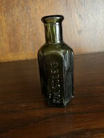 Old green medicine bottle with embossed inscription