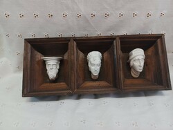 Old plaster heads, in a wooden frame. The Krakow Wawel
