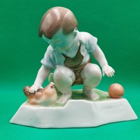 András Zsolnay Porcelain figurine of a child stroking a hen