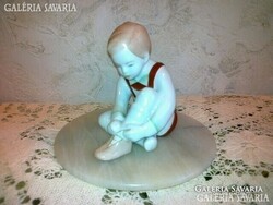 Little boy dressed in aquincum porcelain picture looks beautiful