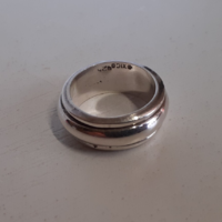 Marked silver ring with a small center swivel