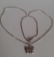 A marked silver necklace with a stamped silver butterfly pendant in good condition