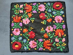 A wonderful, soft, richly embroidered placemat with silk