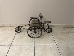Old miniature tricycle made of iron