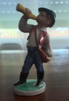 Porcelain figurine of a little boy blowing a horn