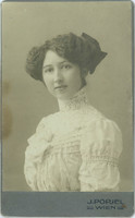 J. Popjel photo studio, Vienna. Portrait of a young, elegant lady with a bow hairdo and a dress with a lace neck.