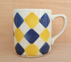 Old granite mug with rhombus pattern