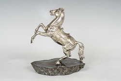 Silver horse statue on an agate pedestal
