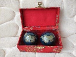 Asian relaxation balls decorated with a musical elephant motif in a box covered with brocade silk