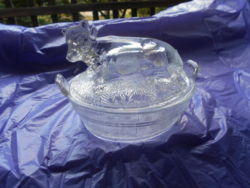 A pressed glass butter container with a cow figure on the top