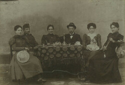 Early 1900s. Young men and women sitting around a table. Wilhelm herter, photography studio,