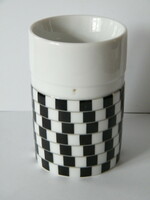 Porcelain mug with black and white optical illusion pattern