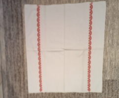 Embroidered old linen tablecloth with a red pattern