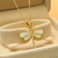 Fairy dragonfly pendant on a cube-shaped gold-colored chain.