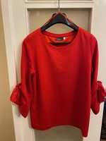 Red, soft, cotton, long-sleeved blouse. With a big bow on the sleeve. I bought it in Austria. Yessica c&a m