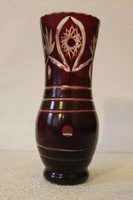 Burgundy crystal vase with polished decoration.