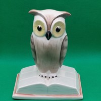Owl figurine sitting on a calendary aurel aquincum book