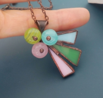 A glass jewelry pendant made of pastel colors, a handcrafted work
