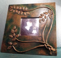Decorative small wall mirror, wrapped around with copper tendrils, on a painted wooden base, 340 grams, approx. 25x25 cm