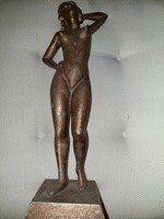 Female nude sculpture made of metal