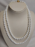 Long necklace made of snow-white porcelain eyes with an old retro beautiful pattern
