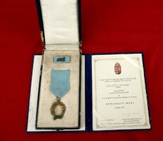 20-year service badge with award box + donation document. 2002
