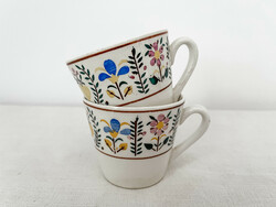 A pair of granite coffee cups - a pair of mocha cups with a small flower pattern