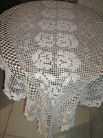 Beautiful white hand-crocheted boat-shaped lace tablecloth with floral pattern