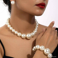 An elegant shaped jewelry set made of pearls of unusual sizes. The needle is made of medical steel.