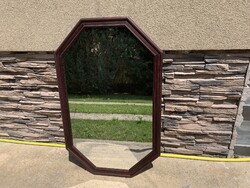 Antique octagonal mirror in a wooden frame, 101 x 64 cm.