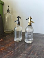 Two 2-deciliter soda bottles, one with acid-etched or sandblasted finish, the other with the cap