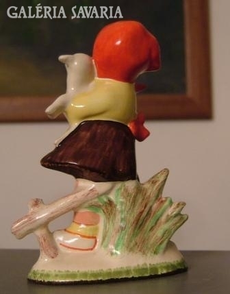 Old ceramic figure. Girl with lamb.