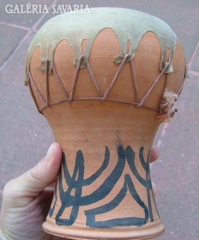 Ceramic drum with leather coating.