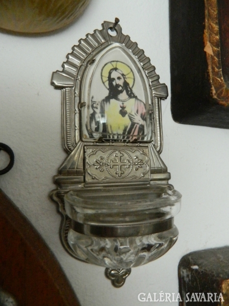 Antique glass container holding holy water with the portrait of Jesus