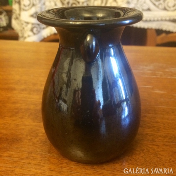 Vase with little black badger