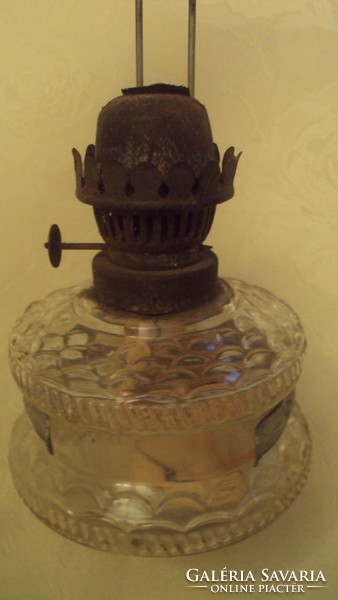 Old kerosene lamp with a glass body that can be hung on the wall.