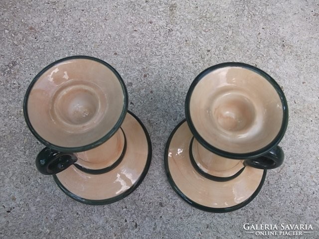 A pair of candle holders with handles for the garden table and wine cellar