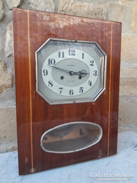 An elegant wall clock with a rare form of old amber