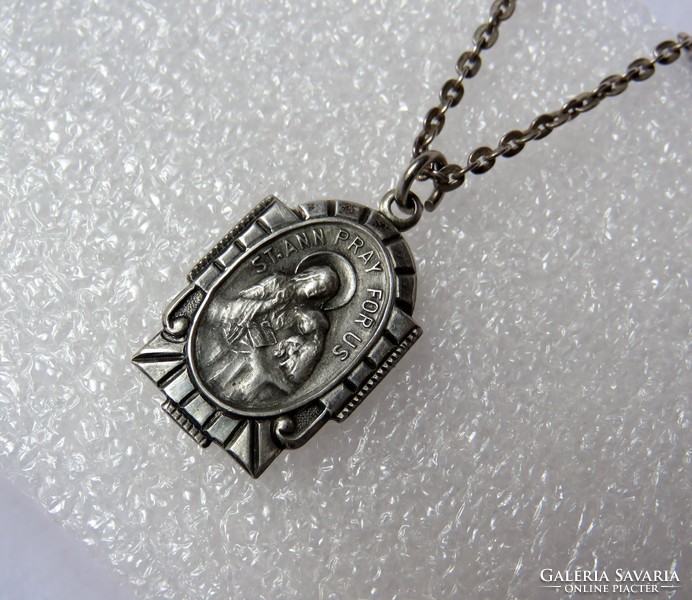 Beautiful, antique silver pendant with a religious theme