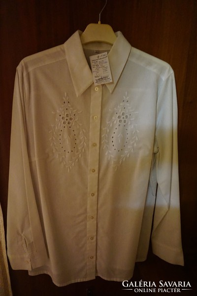 Hevesi is a traditional white embroidered and fashioned long-sleeved blouse for women.