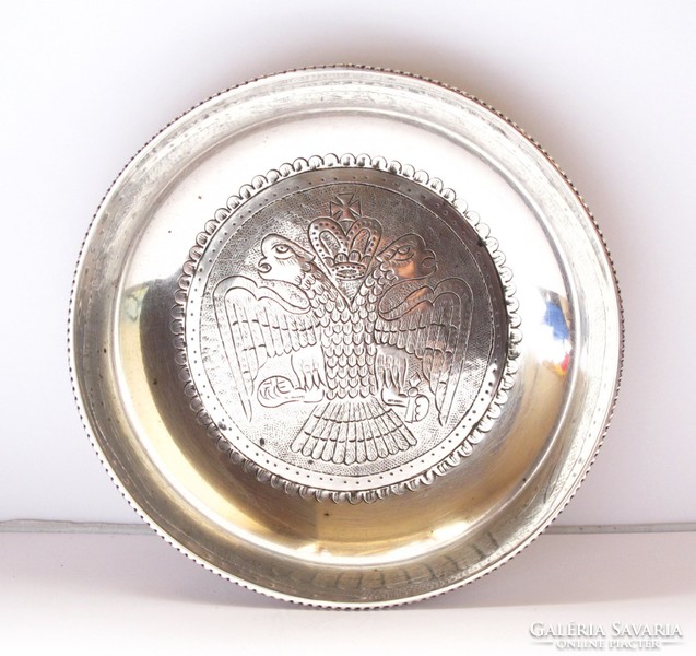 Old silver bowl decorated with a double-headed imperial eagle.