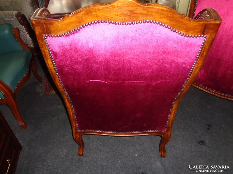 Antique baroque armchairs paired with burgundy velvet upholstery