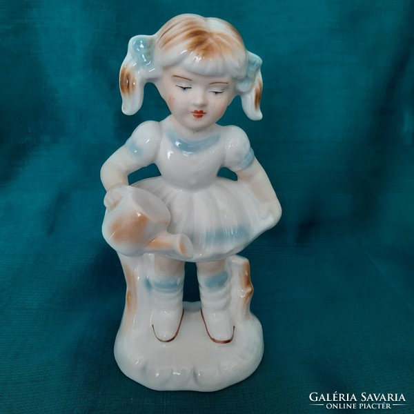 Porcelain girl with a watering can