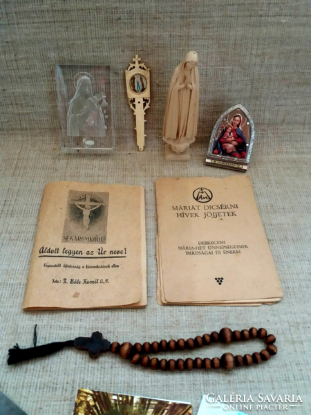 Old prayer books in glass frames with a small picture of Mary and her child