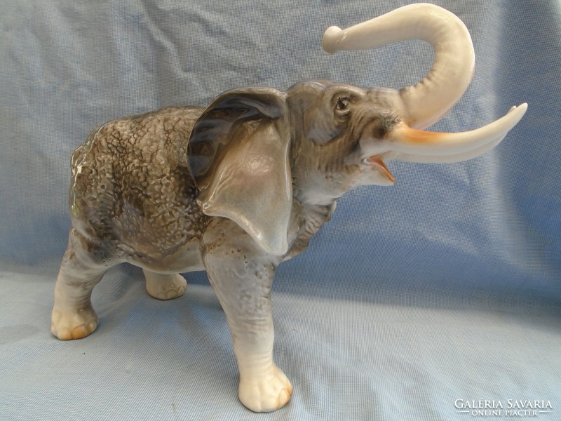 Old antique large elephant statue in porcelain display case