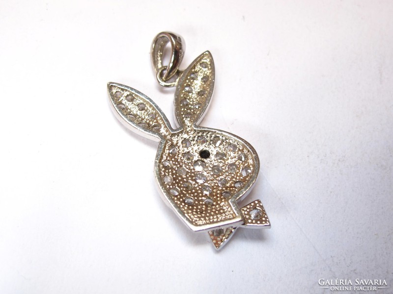 Large silver playboy pendant with stones.