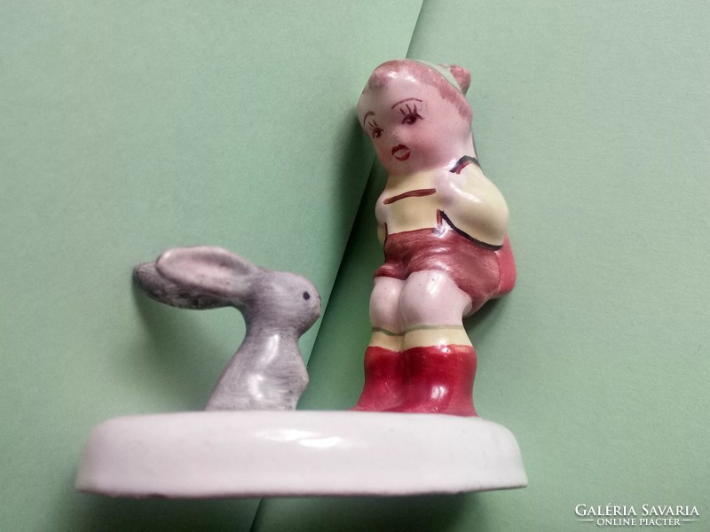 A rare Bodrogkeresztúr ceramic figurine of a hunter with a bunny