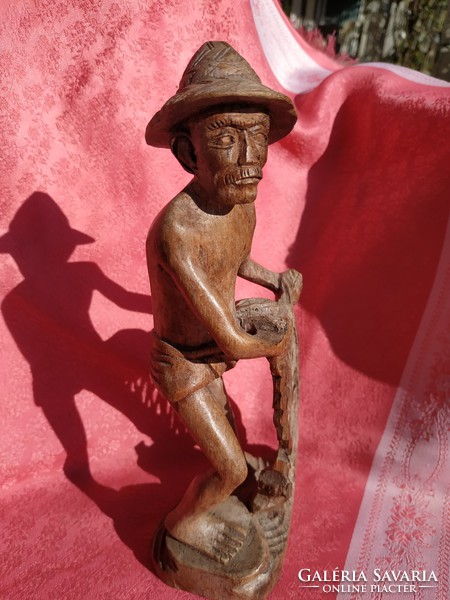 Old wood carving, fisherman casting his net