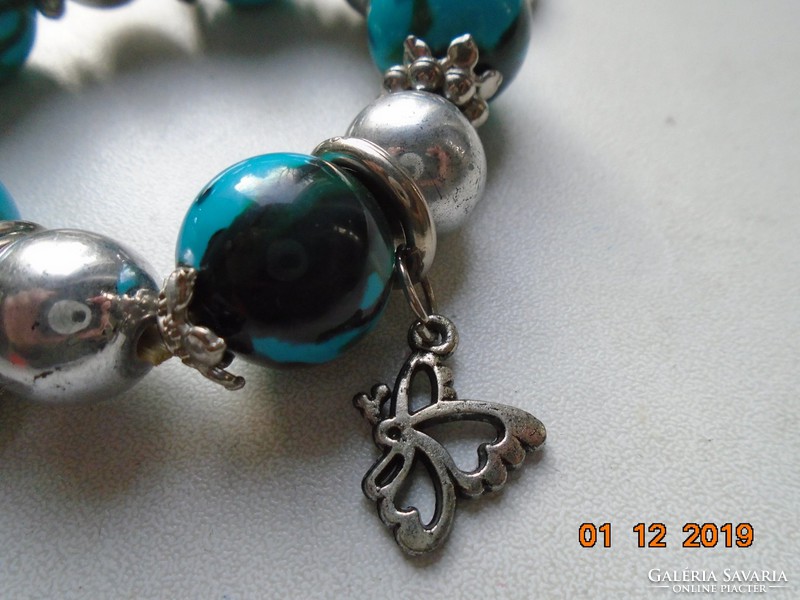 Silver-plated flower in a socket, bracelet with pendants made of green and silver beads