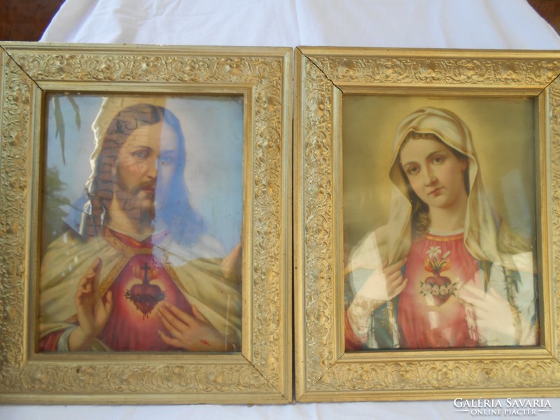 A pair of holy pictures in a golden frame